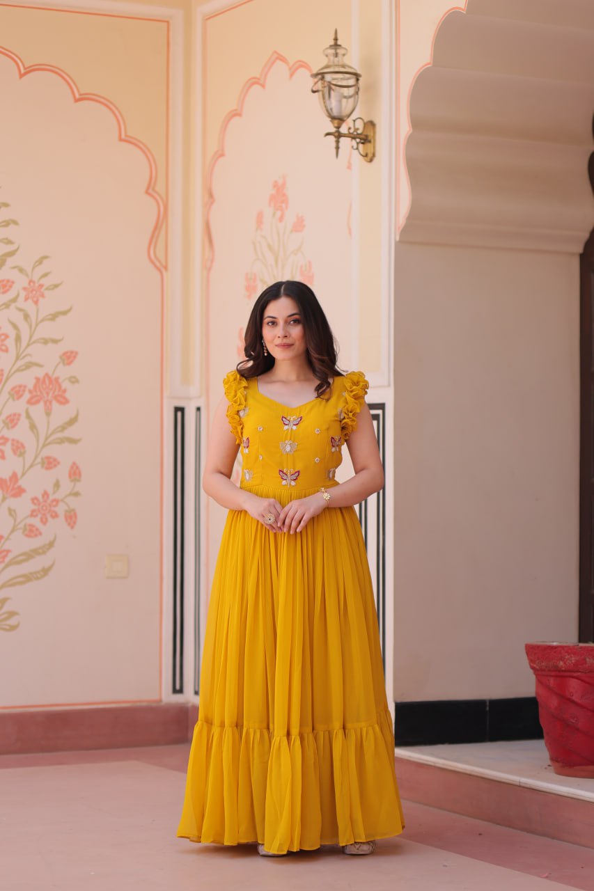 Lavi 7-meter flared designer gown in faux blooming fabric with sequin & bead embroidery, V-neck & frill shoulders – perfect for weddings & parties.